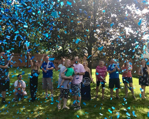 This couple was surprised it was another boy as blue confetti cannons were popped into the air covering them in light blue and shiny blue confetti