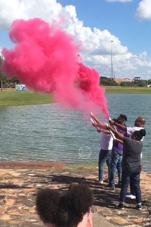 Family  and Friends gather around the lake to announce it's a girl with our pink gender reveal powder cannon