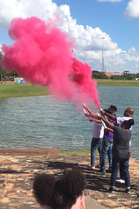 Family and Friends gather around the lake to announce it's a girl with our pink gender reveal powder cannon