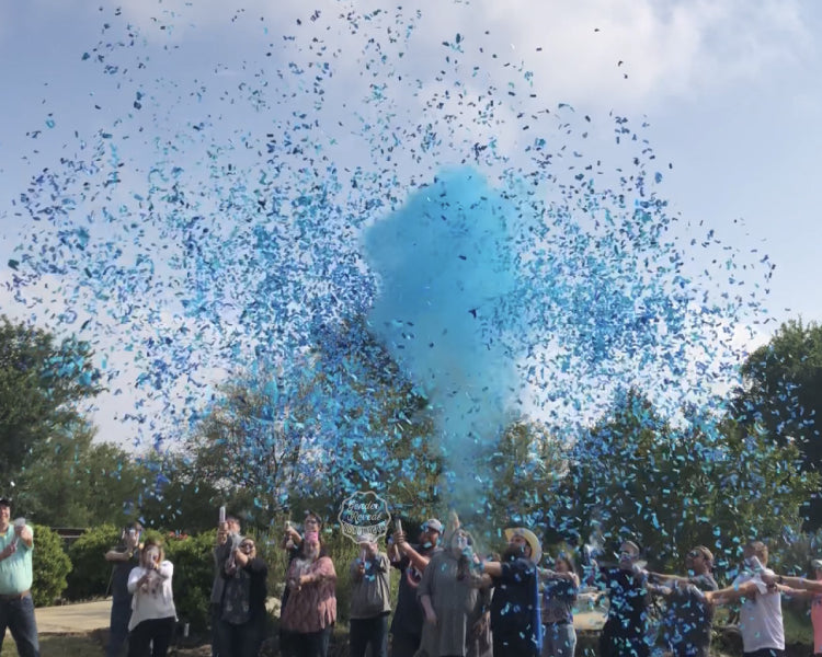 Family and Friends cover the sky using powder and confetti mixture cannons as they reveal the gender of the baby