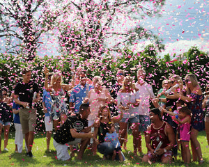 These parents to be were completely covered in dark pink and light pink gender reveal confetti