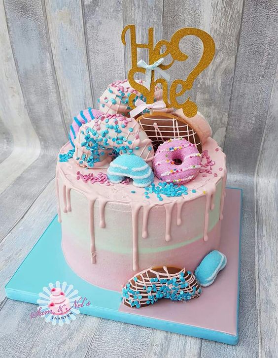 Gender reveal party cake that is doughnut inspired.