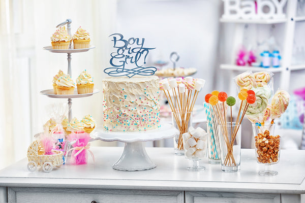 Table full of gender reveal themed treats.