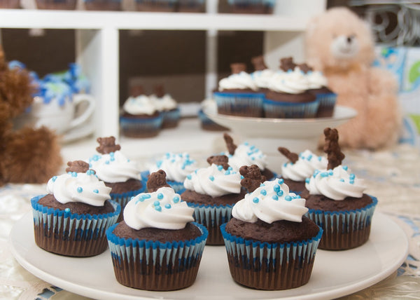 Chocolate Cupcakes plated with icing and blue sprinkles