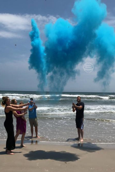 This couple had a beautiful beach gender reveal using our blue powder cannons