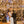 Couple posing at a wedding while gold confetti falls all around them.