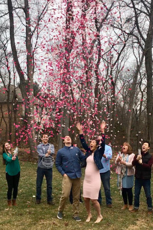 Surprised with our pink confetti cannons, these parents to be are having a girl 