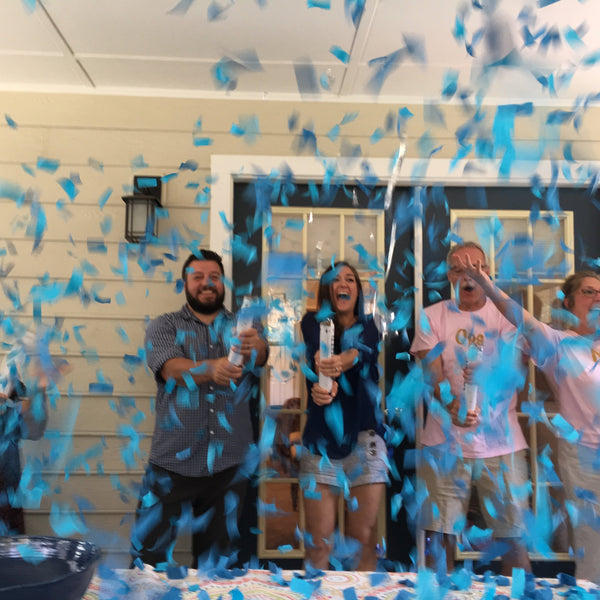 blue confetti cannon gender reveal surprise family parents